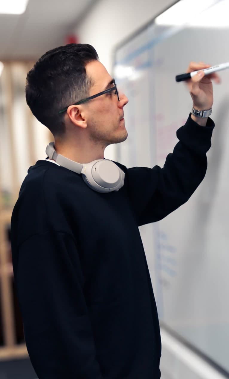 Istvan writing onto a whiteboard.